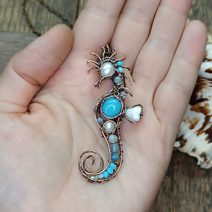 Blue and white seahorse pendant