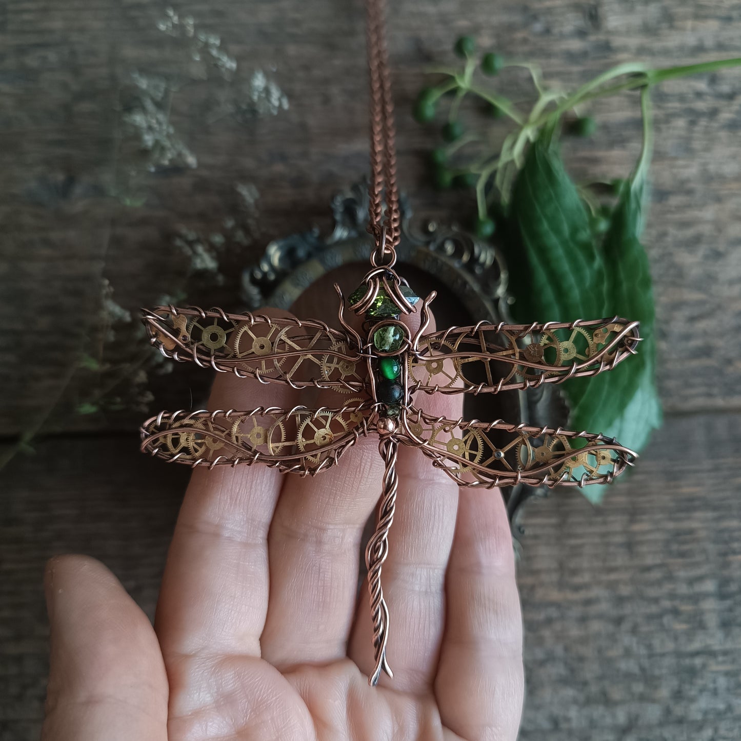Large green dragonfly with golden cogs.