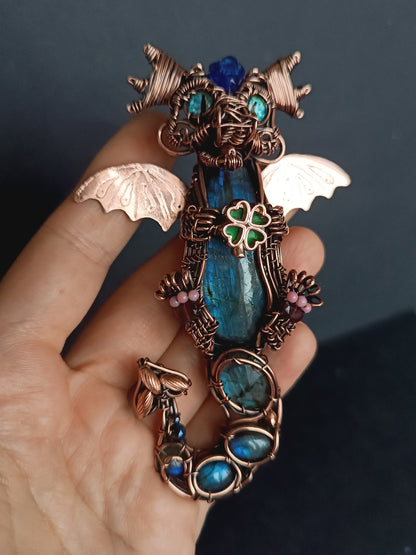 Blue baby dragon with shamrock necklace.