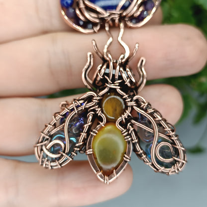 Blue winged bee pollinating on a flower. Pin/pendant.