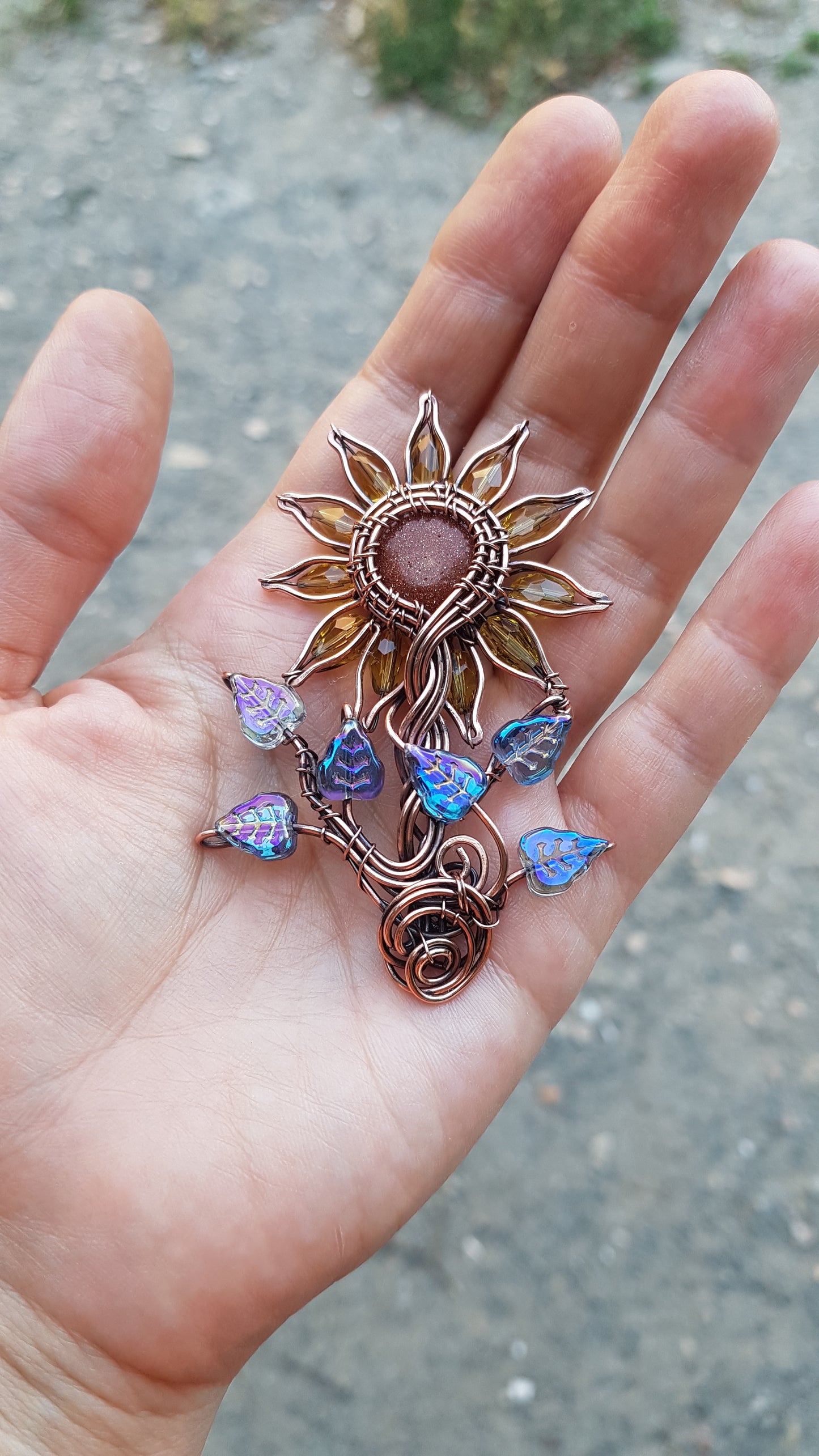 Sunflower pendant with blue leaves