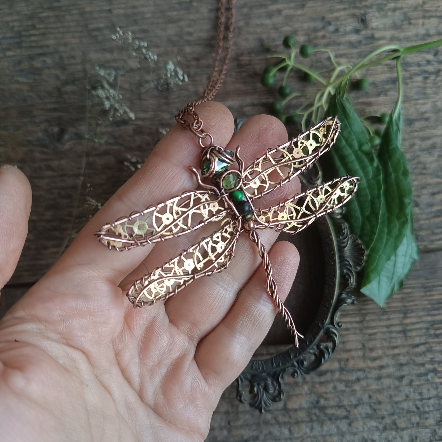 Large green dragonfly with golden cogs.