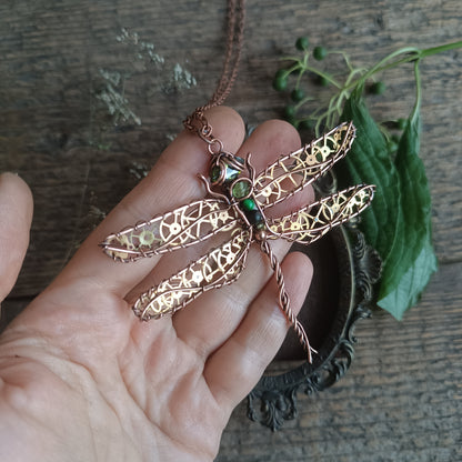 Large green dragonfly with golden cogs.