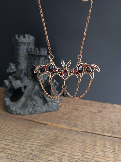 Scarlet dance. Bat necklace.