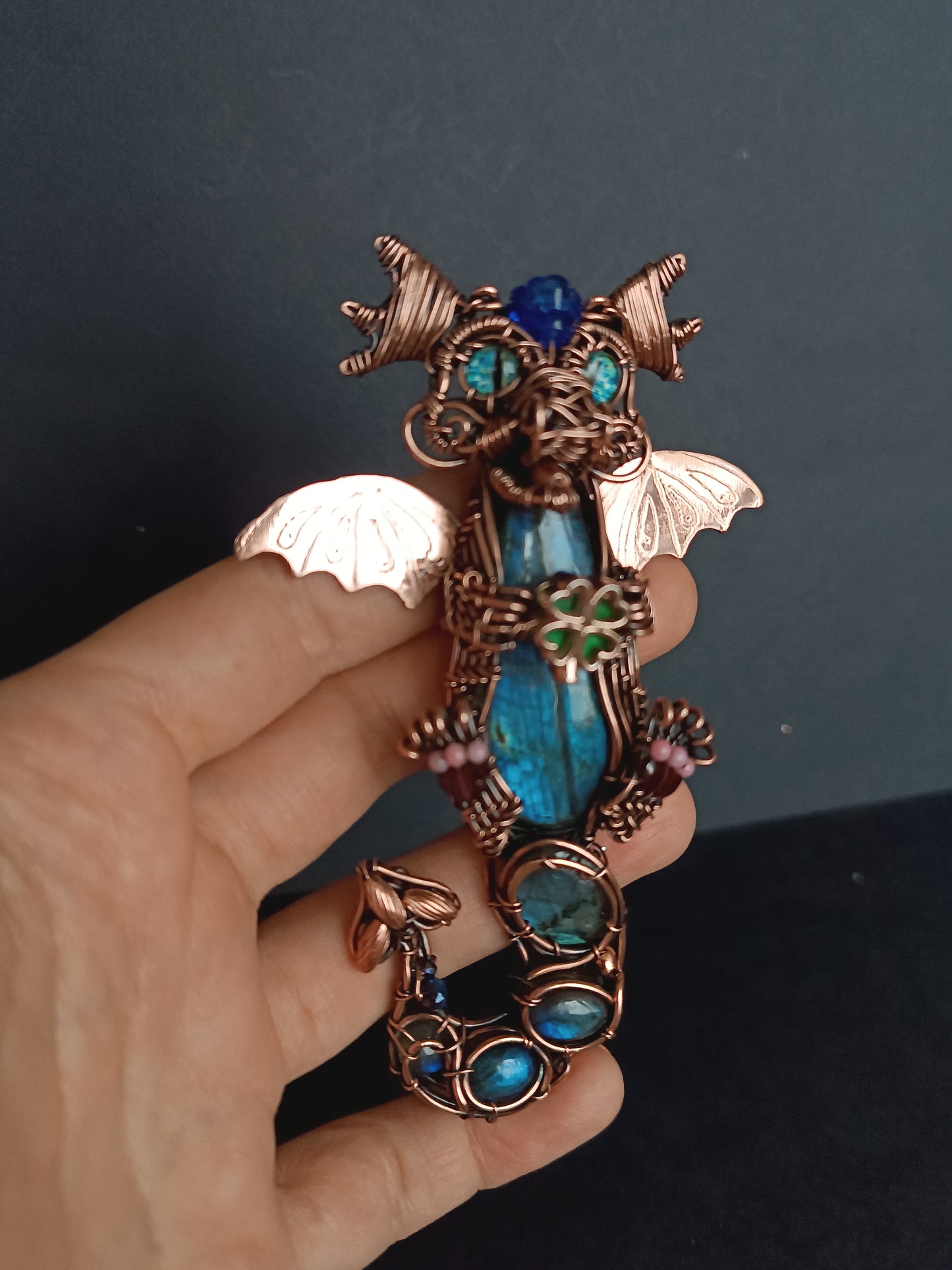 Blue baby dragon with shamrock necklace.