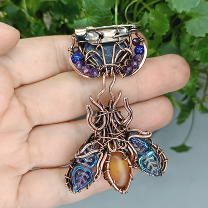 Blue winged bee pollinating on a flower. Pin/pendant.