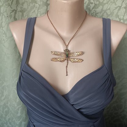Large green dragonfly with golden cogs.
