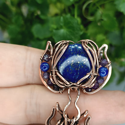 Blue winged bee pollinating on a flower. Pin/pendant.