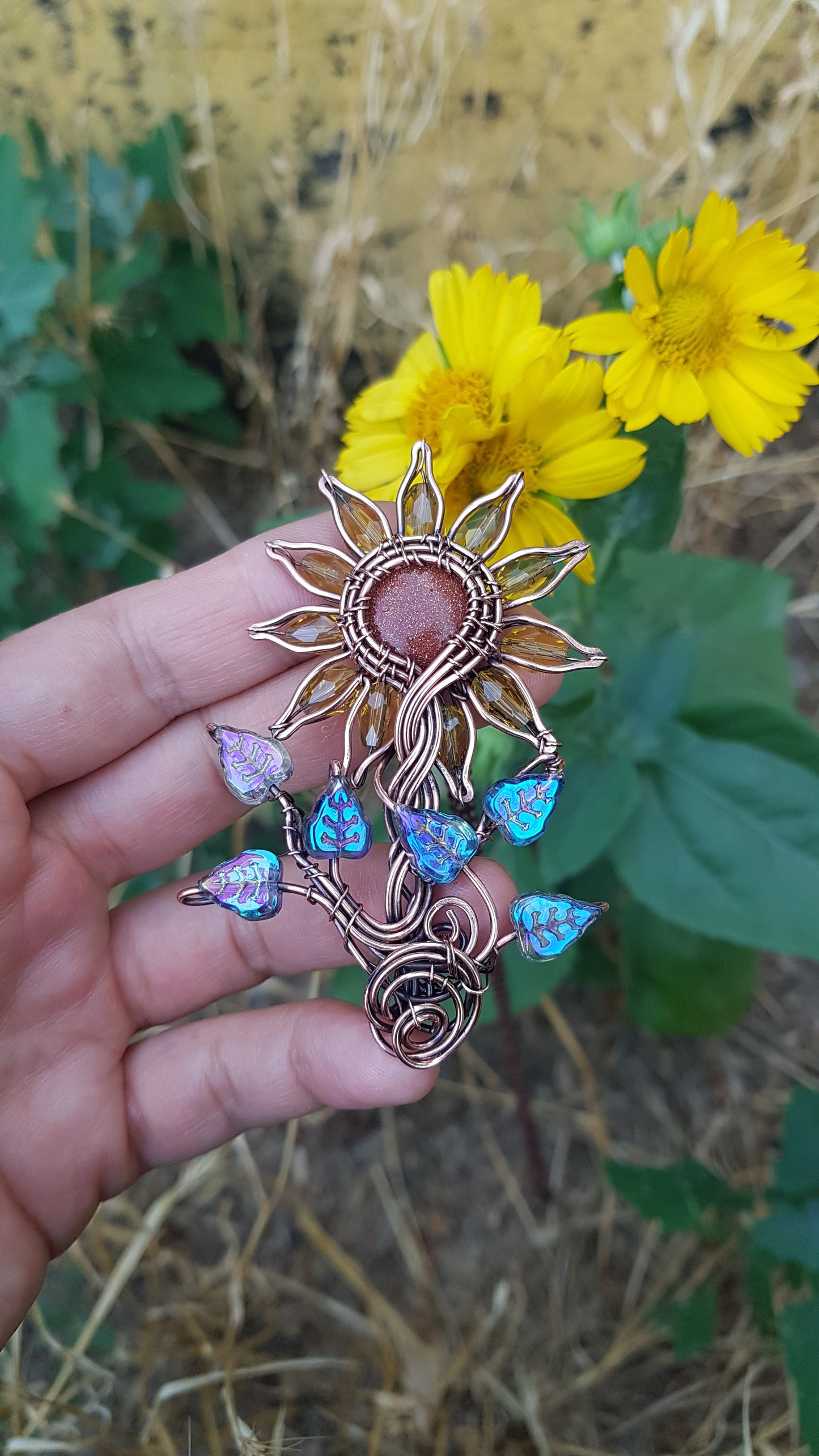 Sunflower pendant with blue leaves