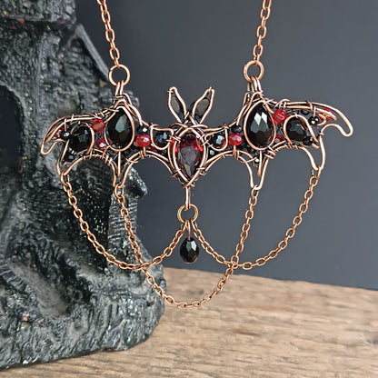 Scarlet dance. Bat necklace.