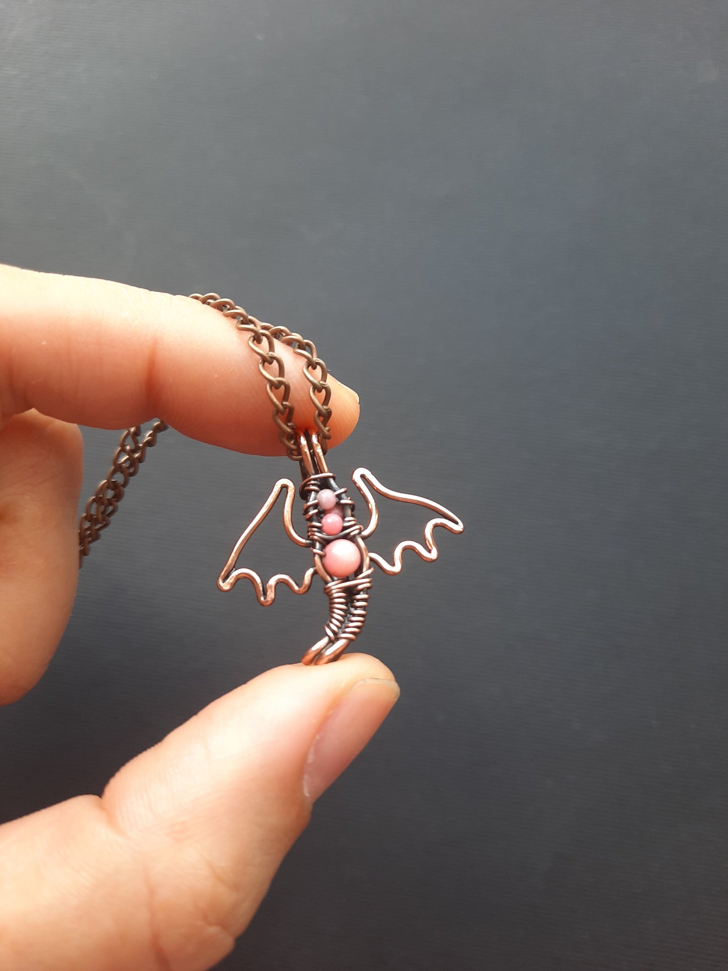 Tiny pink coral dragon pendant