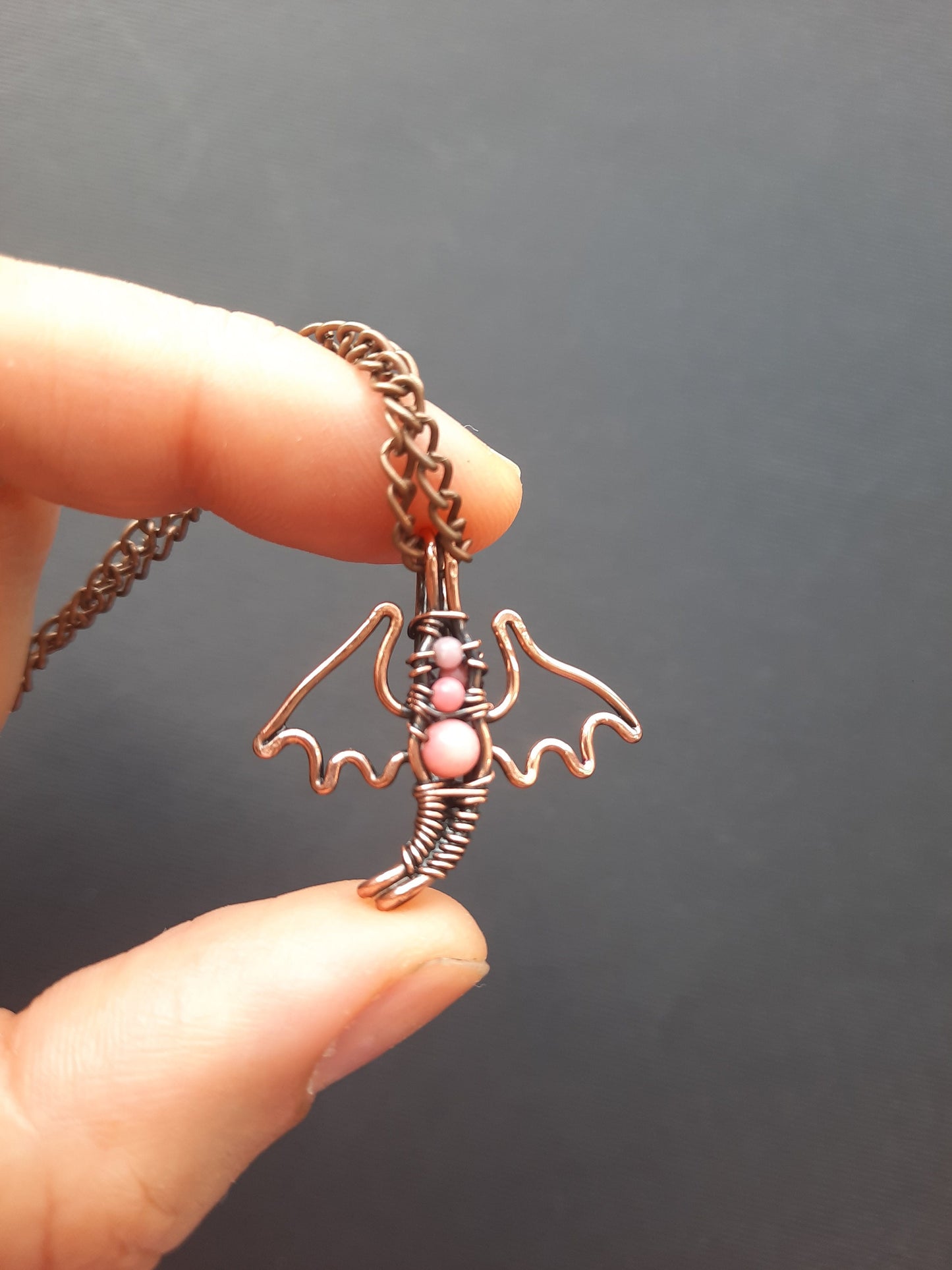 Tiny pink coral dragon pendant